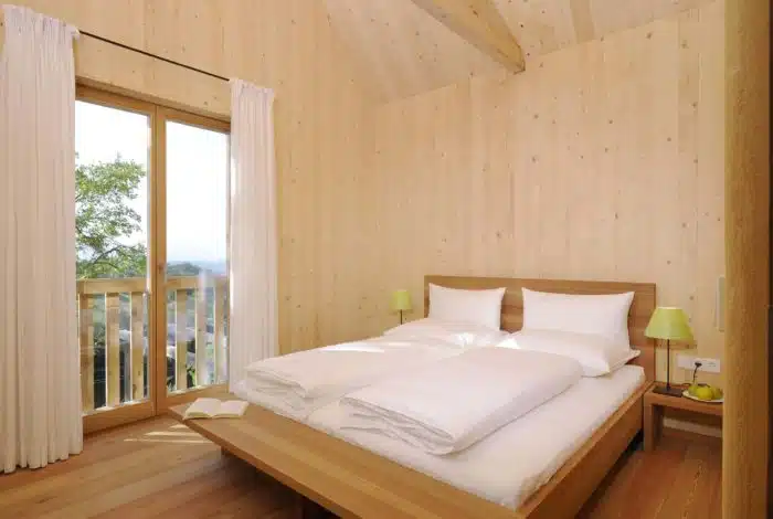 Schlafzimmer in Holz mit Balkon